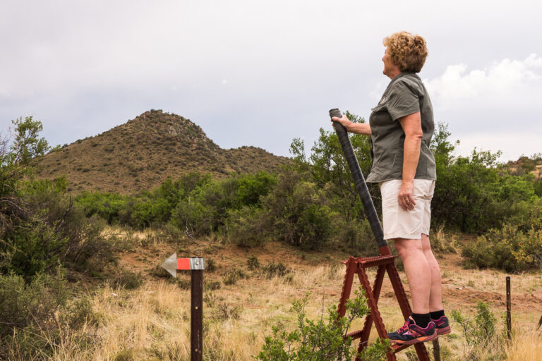 hiker looking at view and guided walking sign karoo activity experience