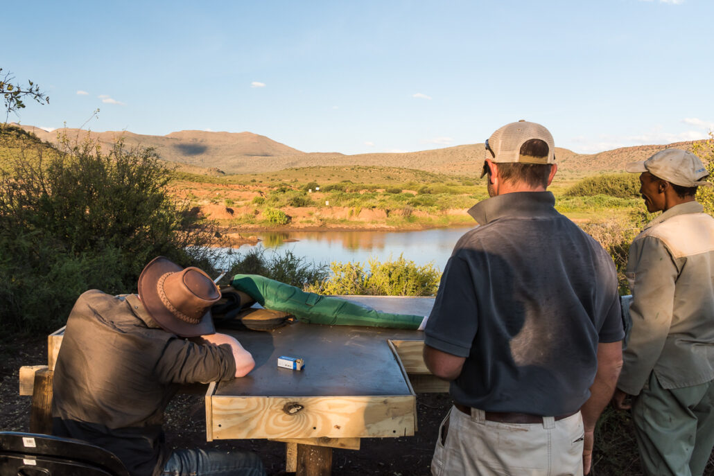 three men clay pigeon shooting over karoo pond activity experience